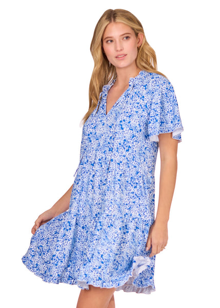 The side of a blonde woman wearing the flowy & sun protective Blue Short Sleeve Tiered Dress from Cabana Life on a white background.