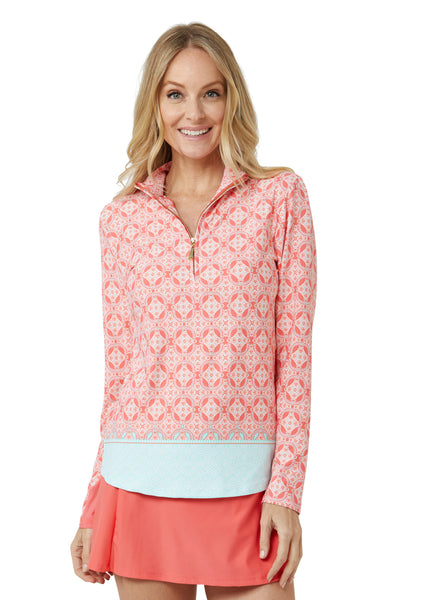 Woman wearing Coral Tides Sport Zip Polo and Coral Classic Swim Skirt